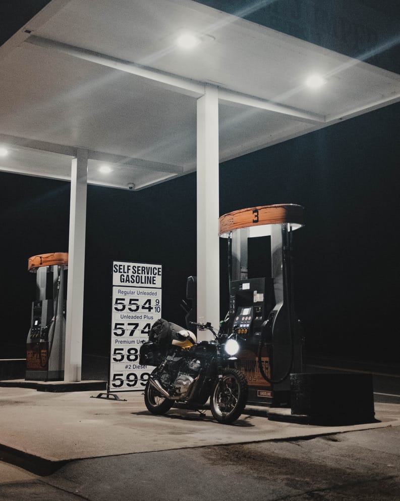 a motorcycle next to a gas pump
