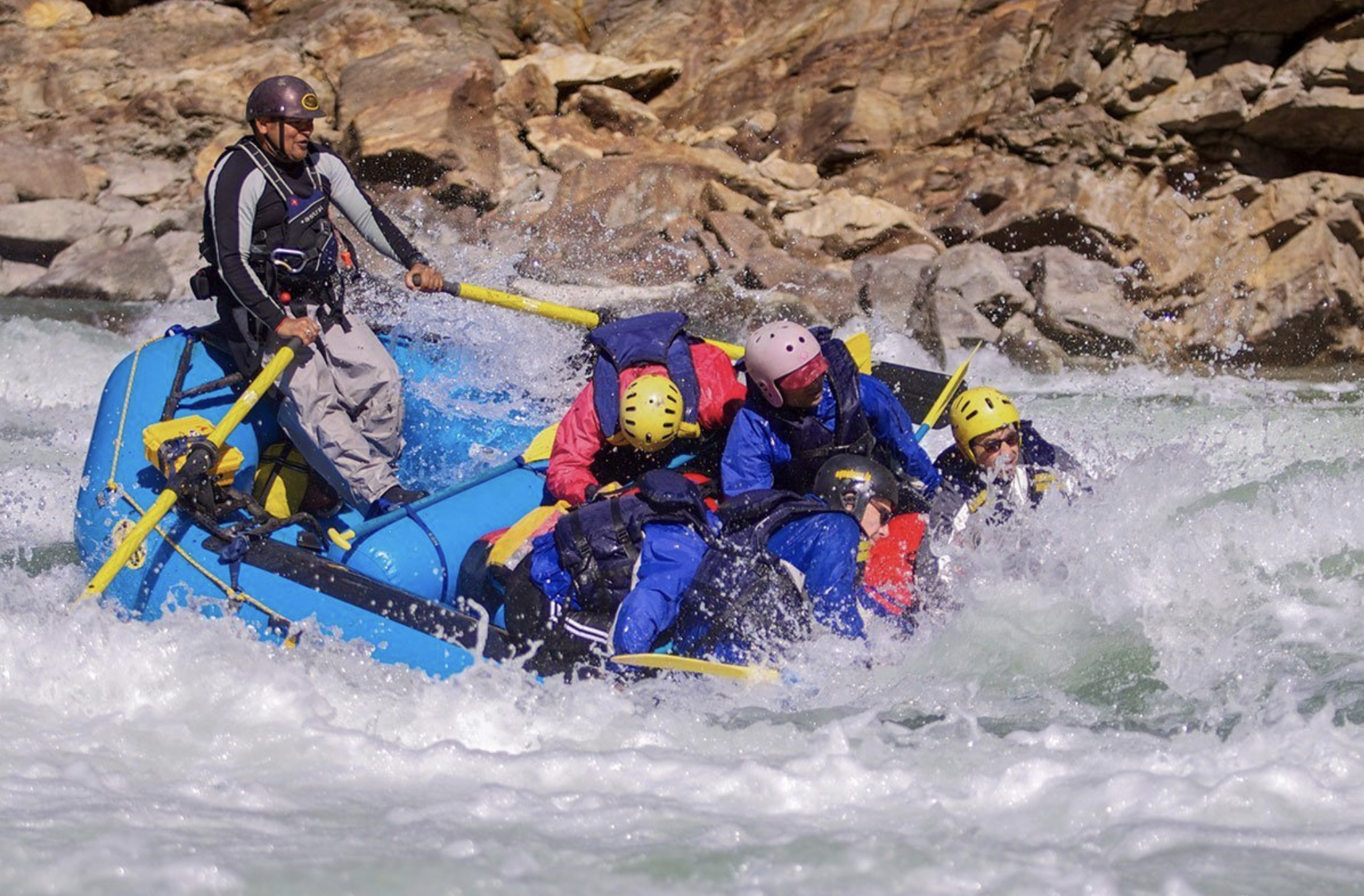 a group of tourists whitewater rafting