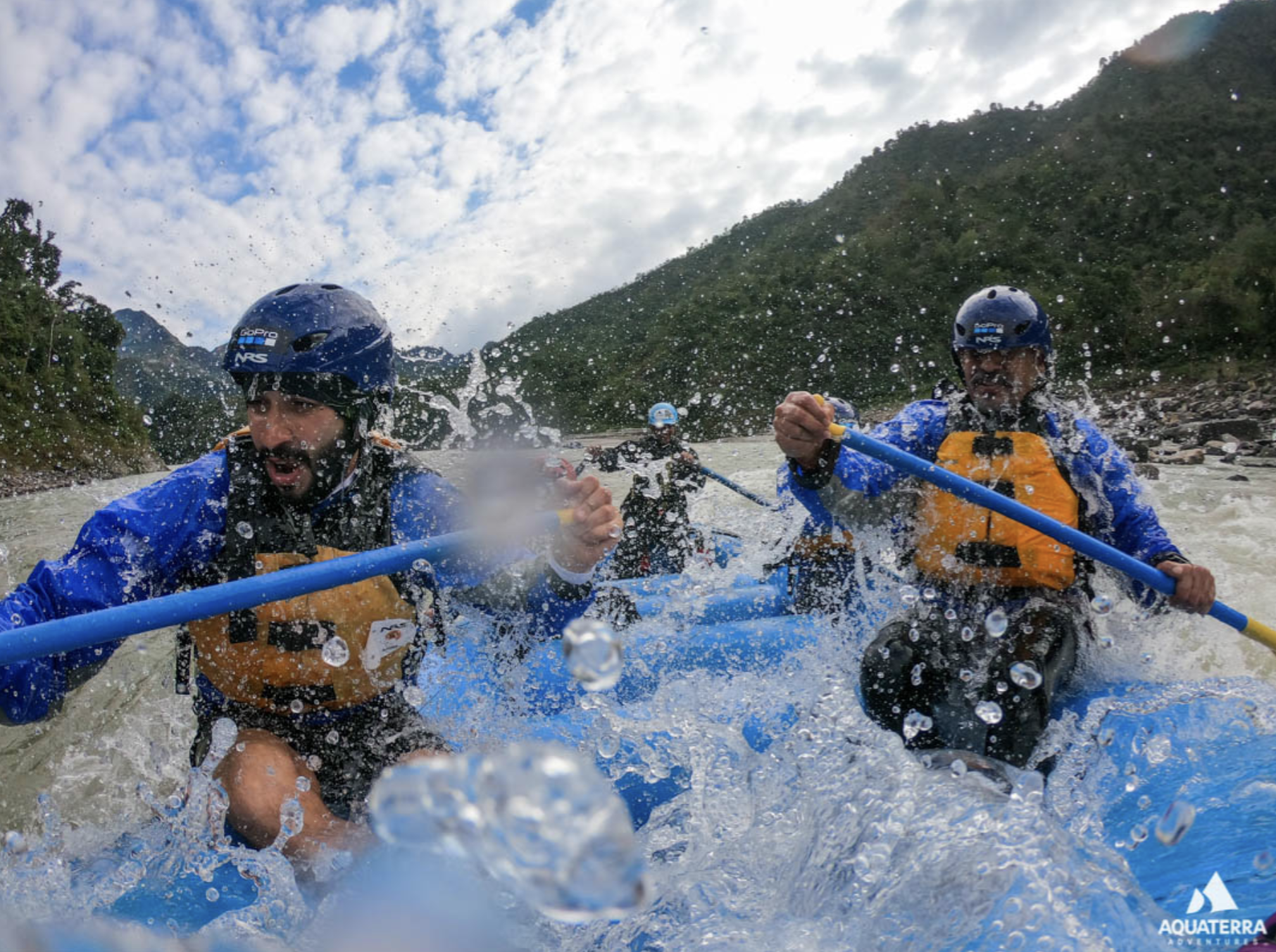 a group of individuals whitewater rafting 