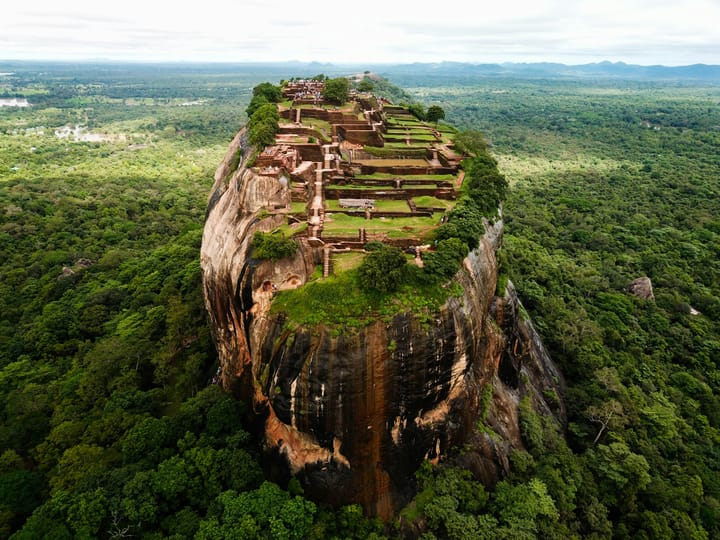 an aerial view of an ancient fort, Sirigaya, on a rock butte rising out of the jungle